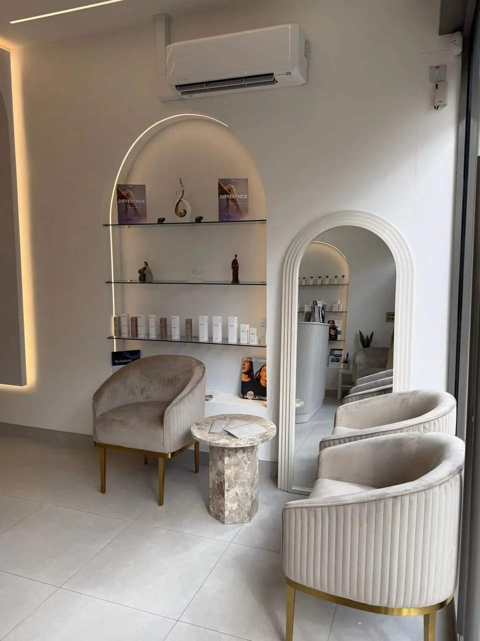 Seating area with arched mirror and product shelves at Etica Northwood