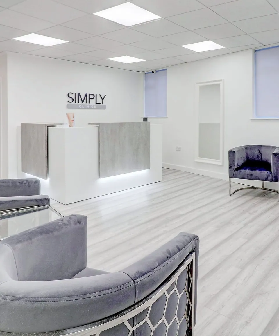Simply Clinics Uxbridge reception desk and grey waiting seats