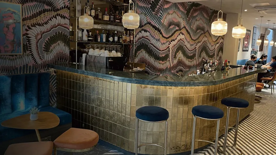 Bar counter and blue stools at Iris Avenue on Store Street.