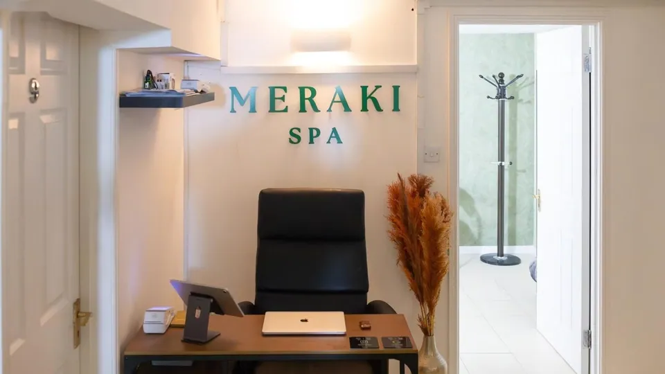 Meraki Spa reception desk with the studio name on the wall.