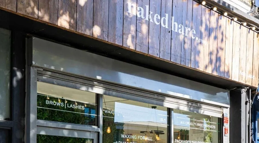 Naked Hare shopfront and wooden fascia on Acre Lane, Brixton.