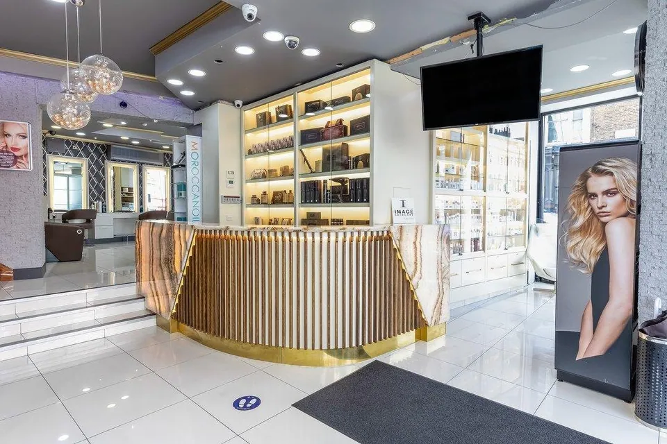 Reception counter, illuminated product shelves and entrance at Sheer Bliss in Dalston.
