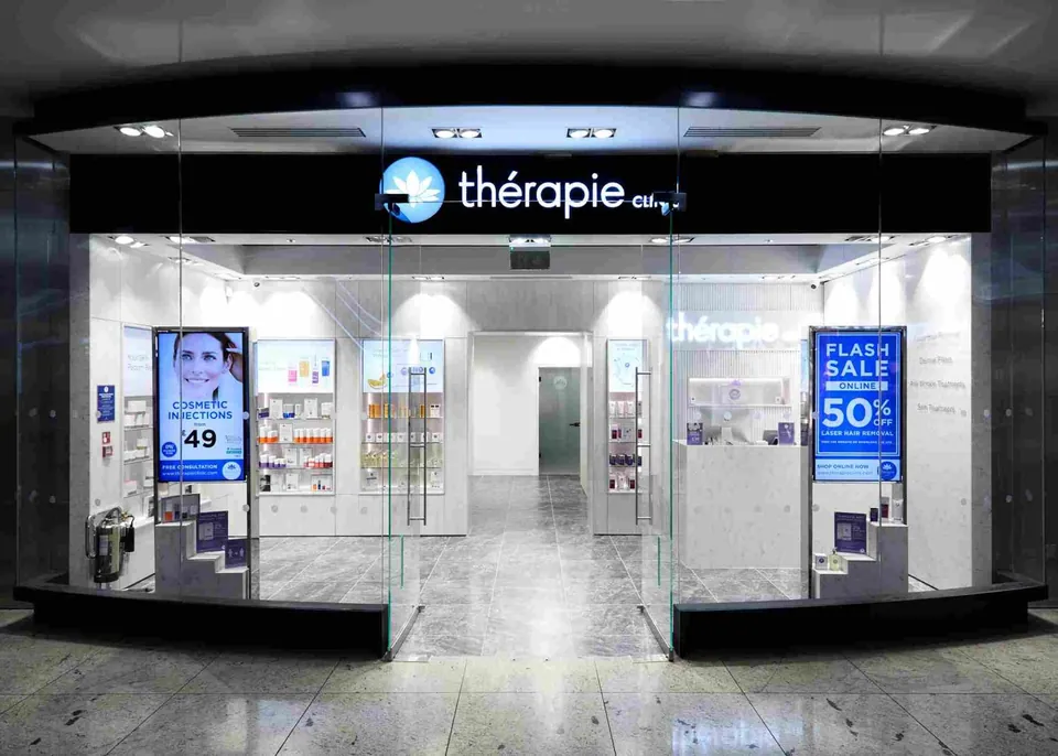 Glass-fronted Thérapie Clinic entrance and reception at Canary Wharf Jubilee Place
