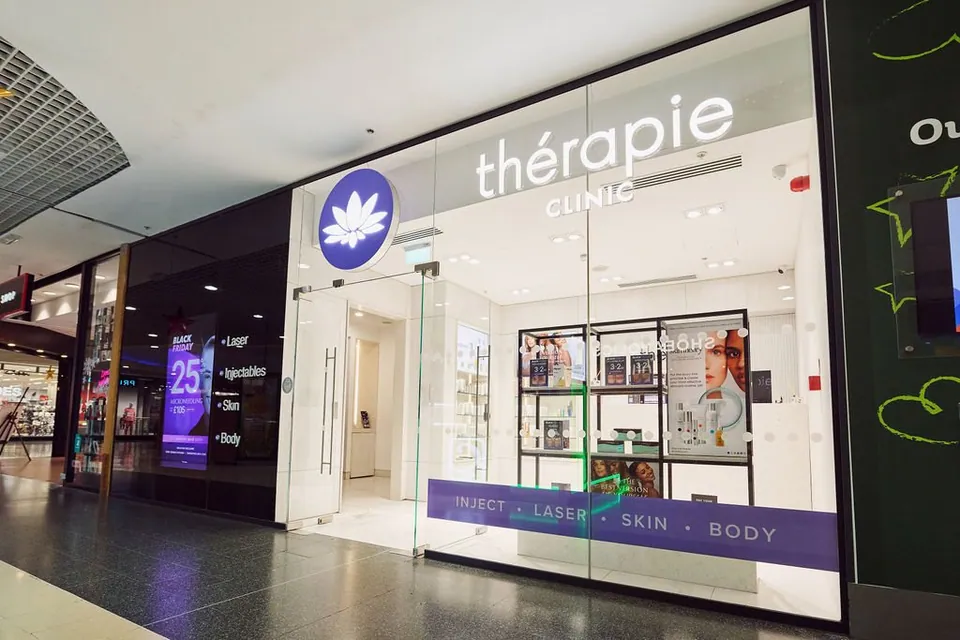 Thérapie Clinic Wood Green glass shopfront opening onto the shopping-centre corridor