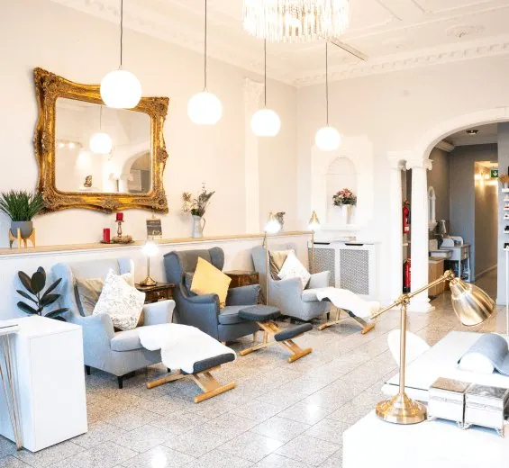 Layana Finchley Central interior with grey lounge chairs, pendant lights and pedicure seating.