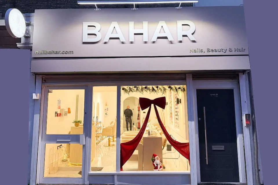 Bahar storefront with purple fascia, illuminated name and glass entrance.