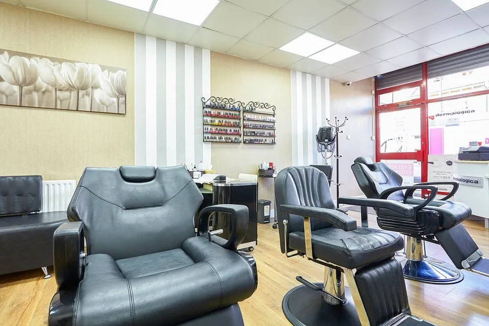 SA Beauty Wood Green interior with salon chairs beside the red-framed entrance.