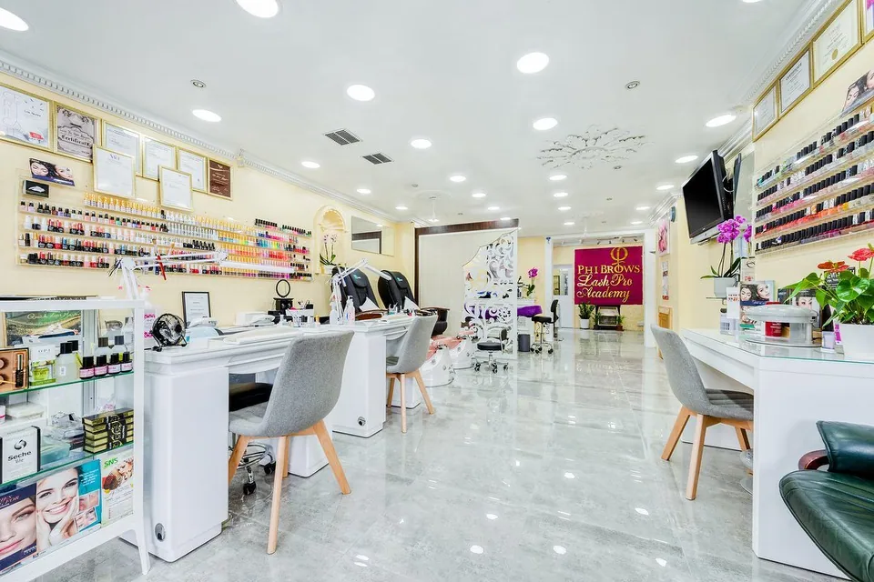 Bright interior of Crown Beauty Eltham with manicure stations and product shelves.