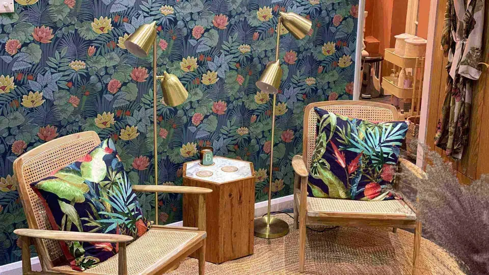 Two wooden chairs with patterned cushions in the Luminis Blackheath waiting area.