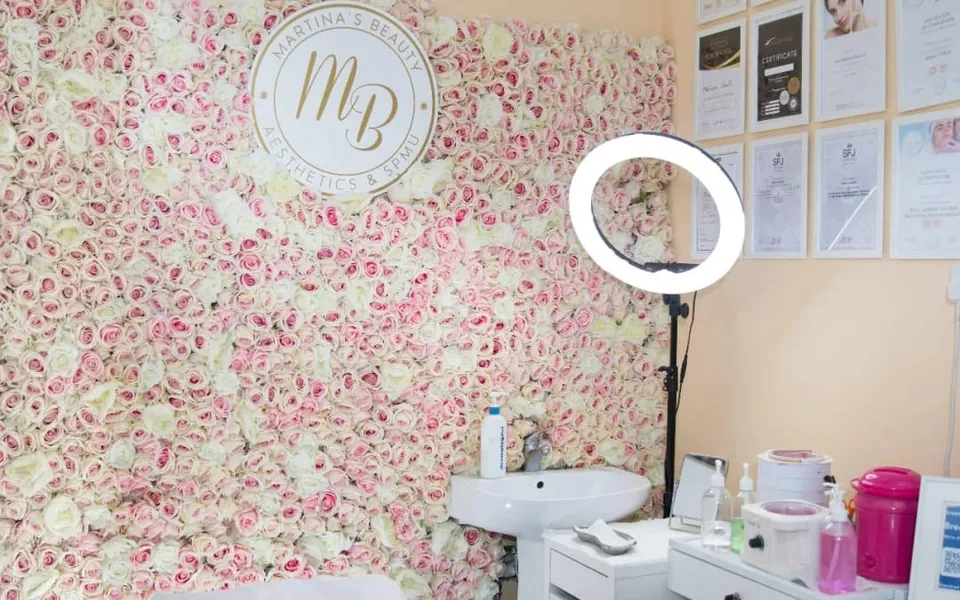 Floral wall, Martina’s Beauty sign and treatment supplies inside the Beckenham studio.