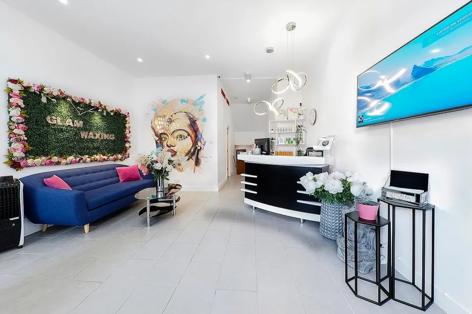 Reception and blue seating at Glam Waxing on Wandsworth Bridge Road