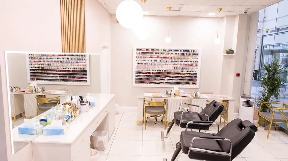 Nail stations and reclining chairs inside Sia at Putney Exchange