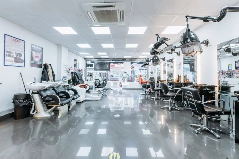 Salon floor with styling chairs and washbasins at Lemoge Kilburn