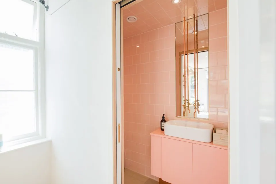 Pink-tiled washbasin area inside the Notting Hill studio