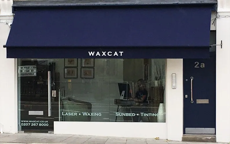 Waxcat shopfront with a dark awning and 2a beside the entrance